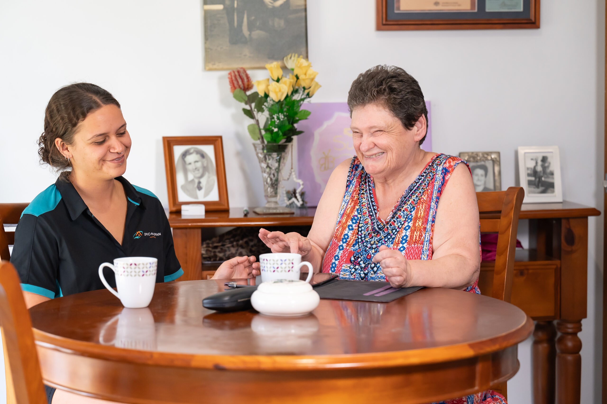 Spic N Span support worker sharing a cup of tea with an NDIS participant at home